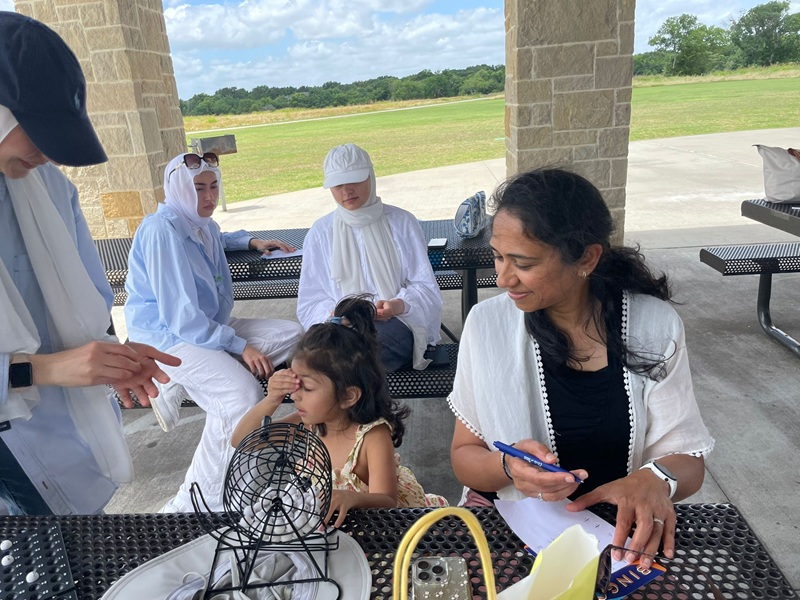 Mother and child at community event bench